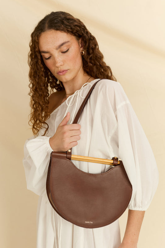 Model wearing the Celine half moon leather shoulder bag facing down