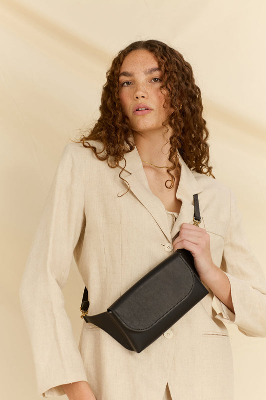 Close up of model wearing the Effie leather belt bag in black across her chest