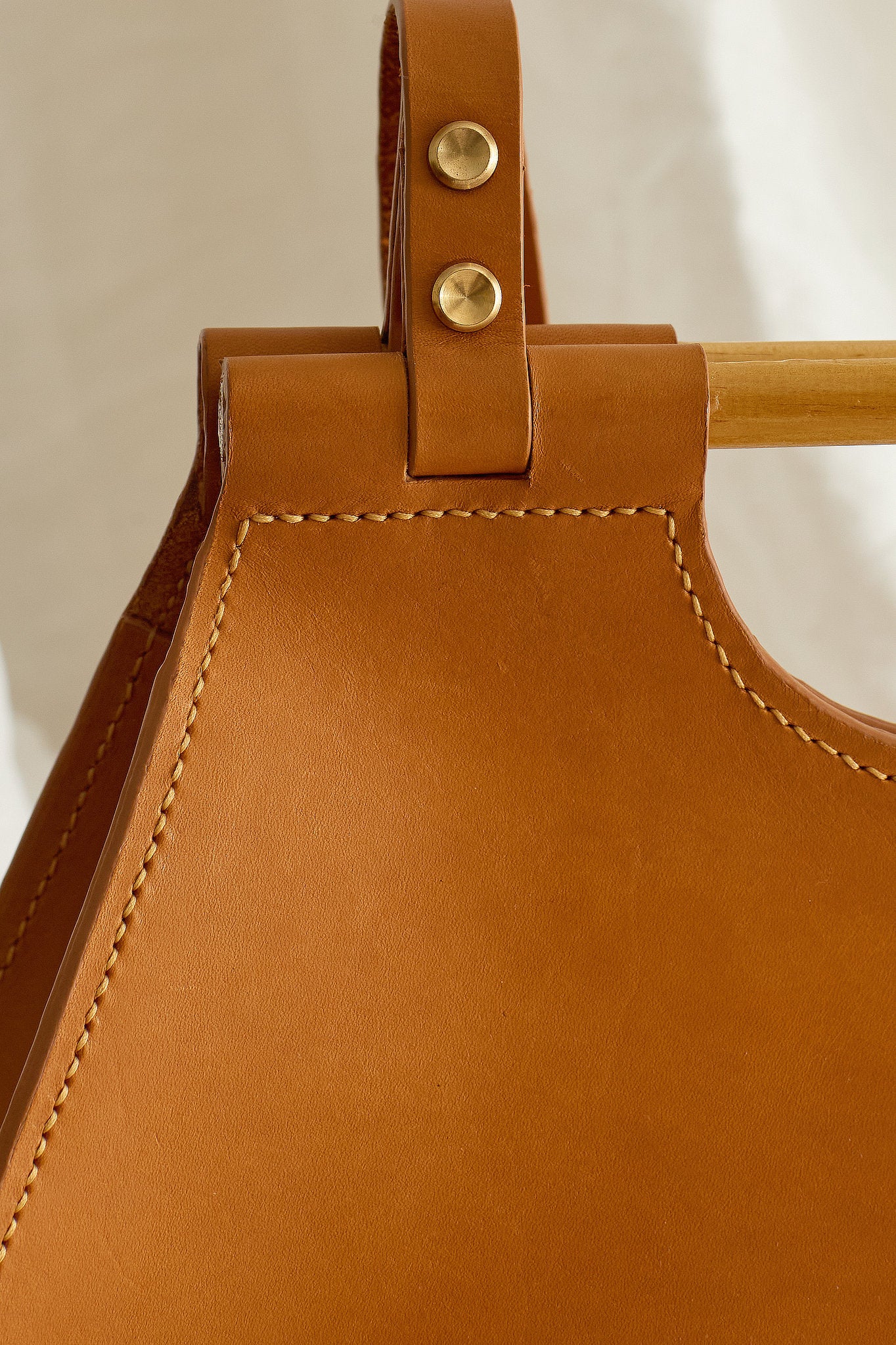 Close up of the Ophelia leather tote bag in tan focused on stitching detail
