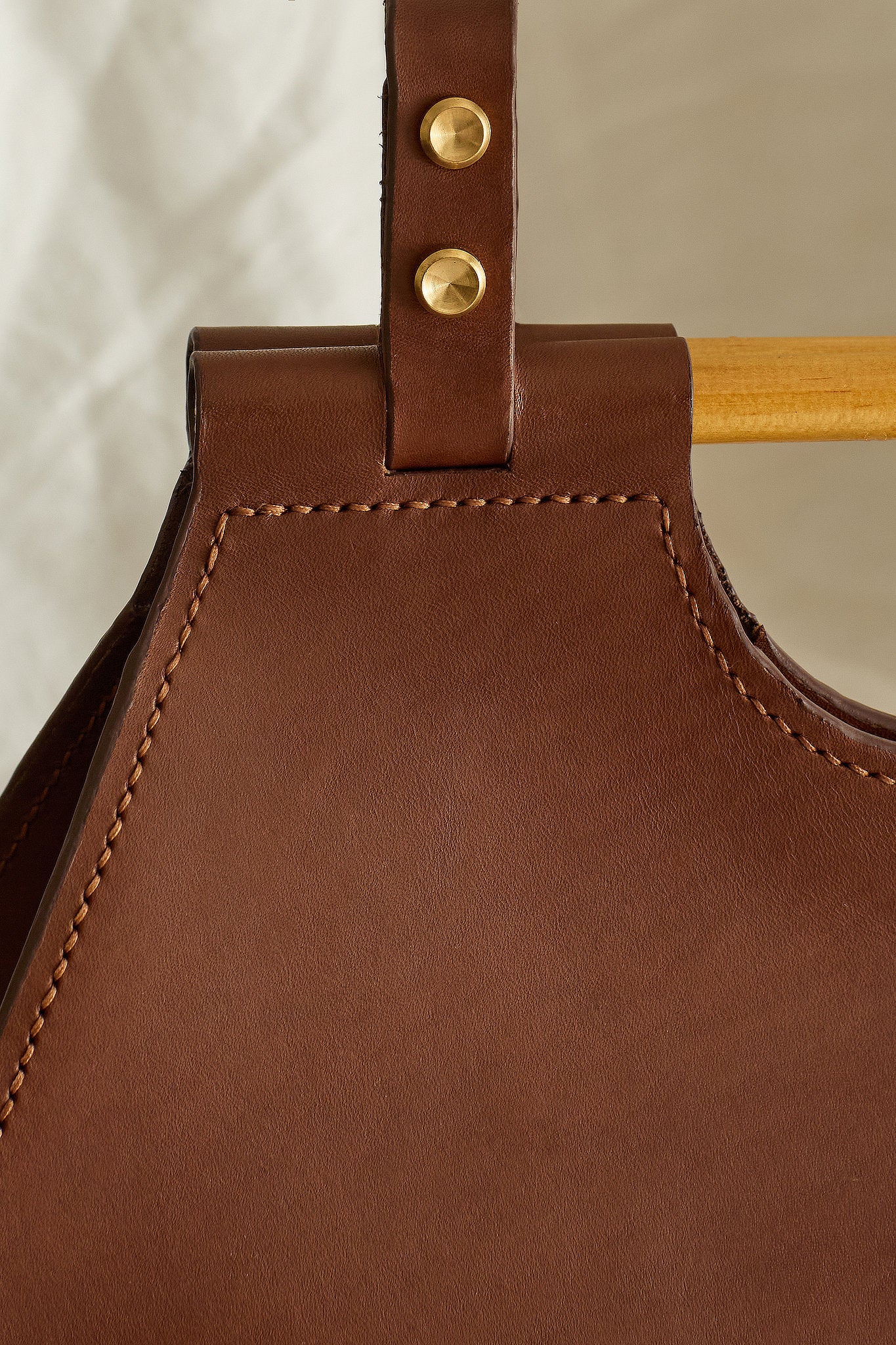 Close up of the Ophelia leather tote bag in brown focused on stitching details