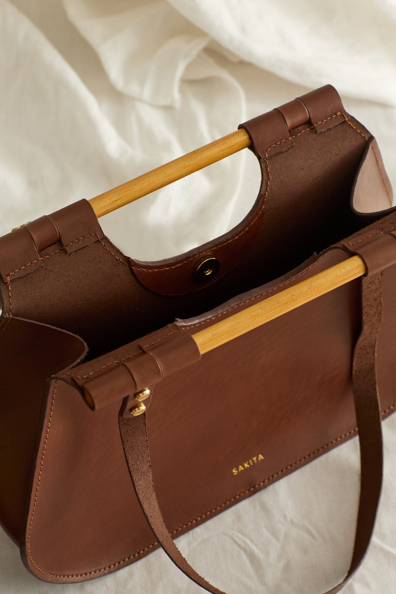 Aerial view of the Ophelia leather tote bag in brown showing the raw interior