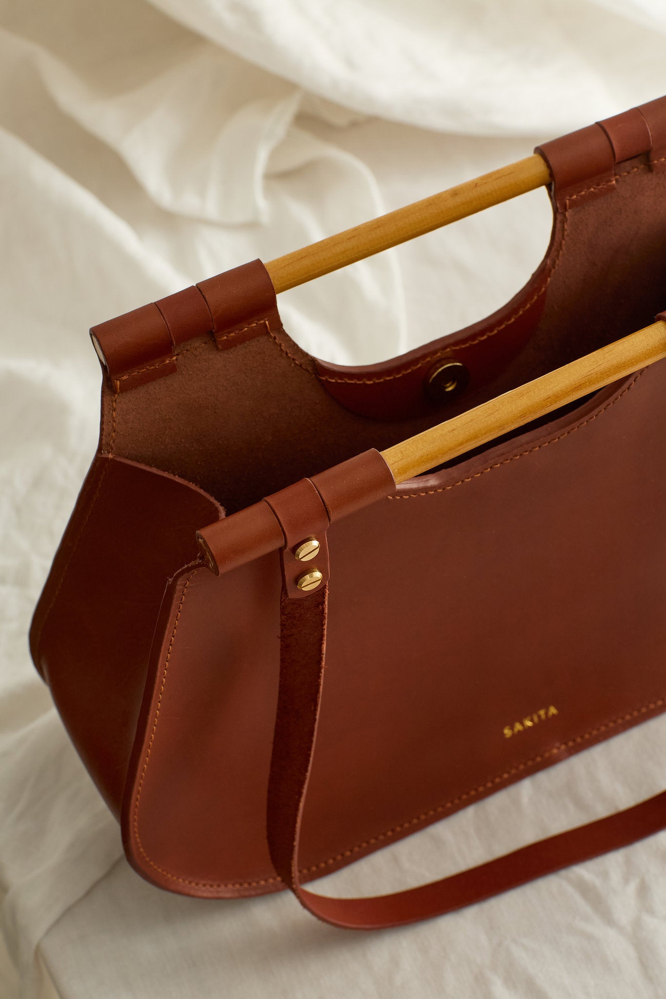 Aerial view of the Ophelia leather tote bag in maroon showing the raw interior
