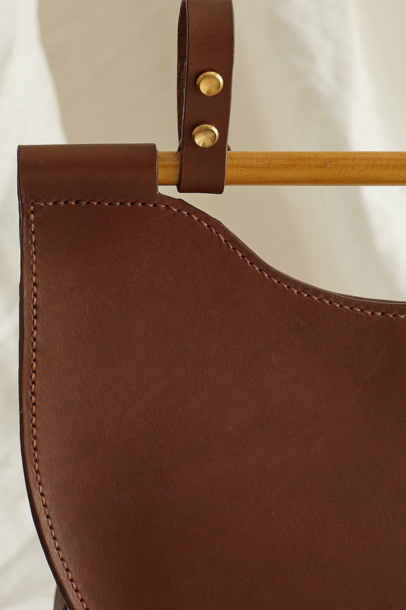 Close up of the Celine half moon leather bag in brown showing hand-stitch details