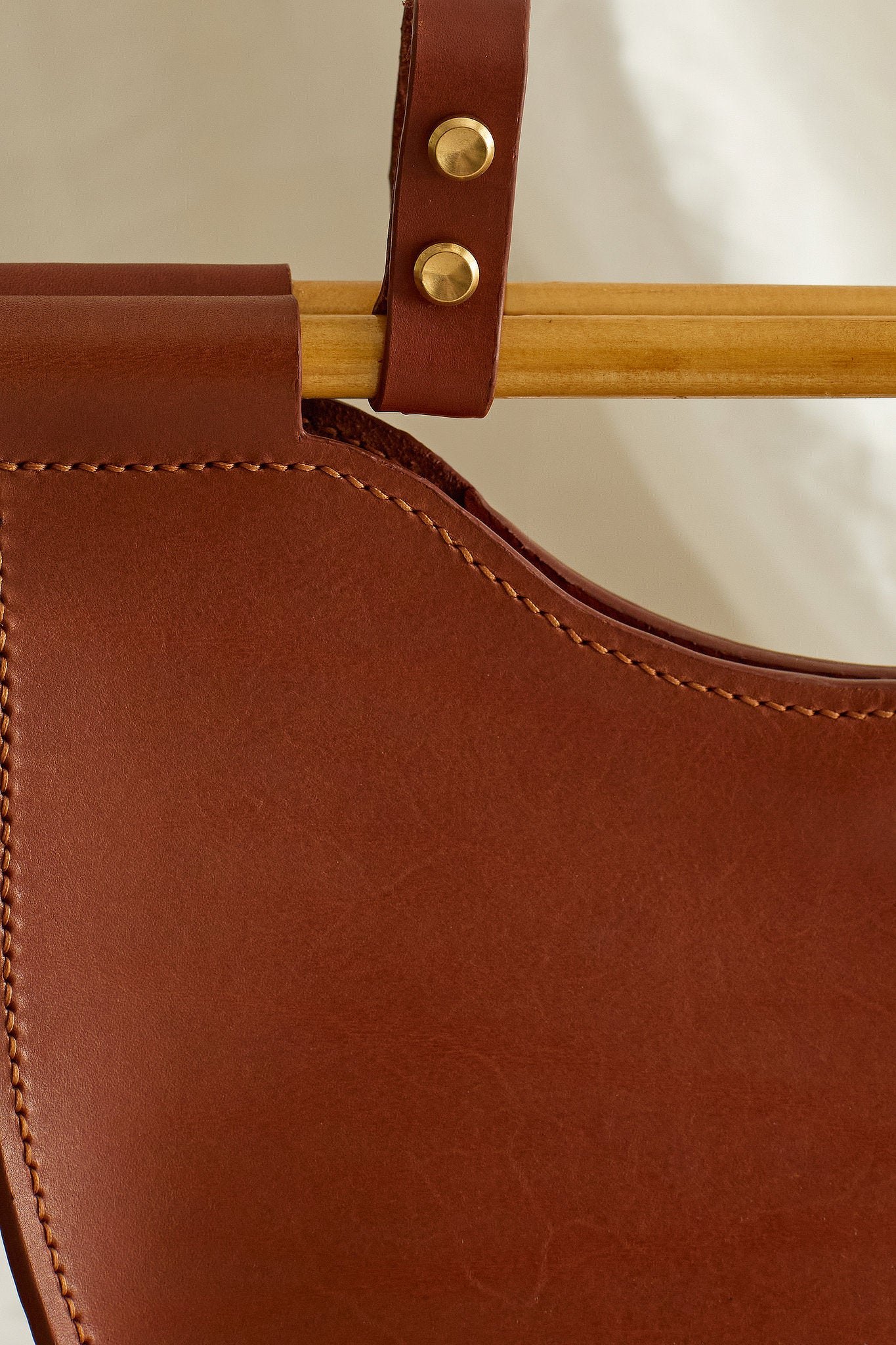 Close up of the Celine half moon leather bag showing wooden dowel and brass
