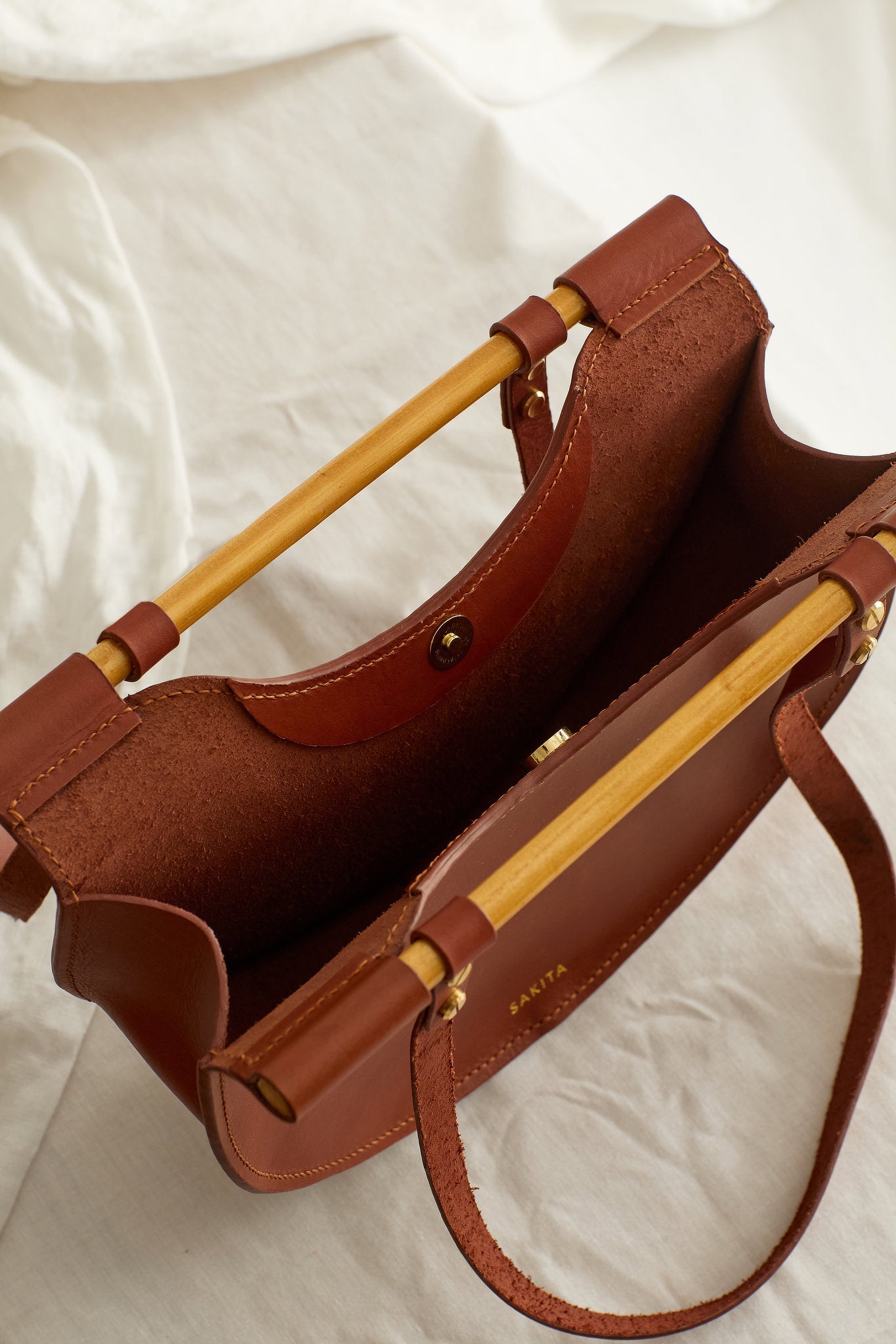 Aerial view of the Celine shoulder bag in maroon showing the raw interior