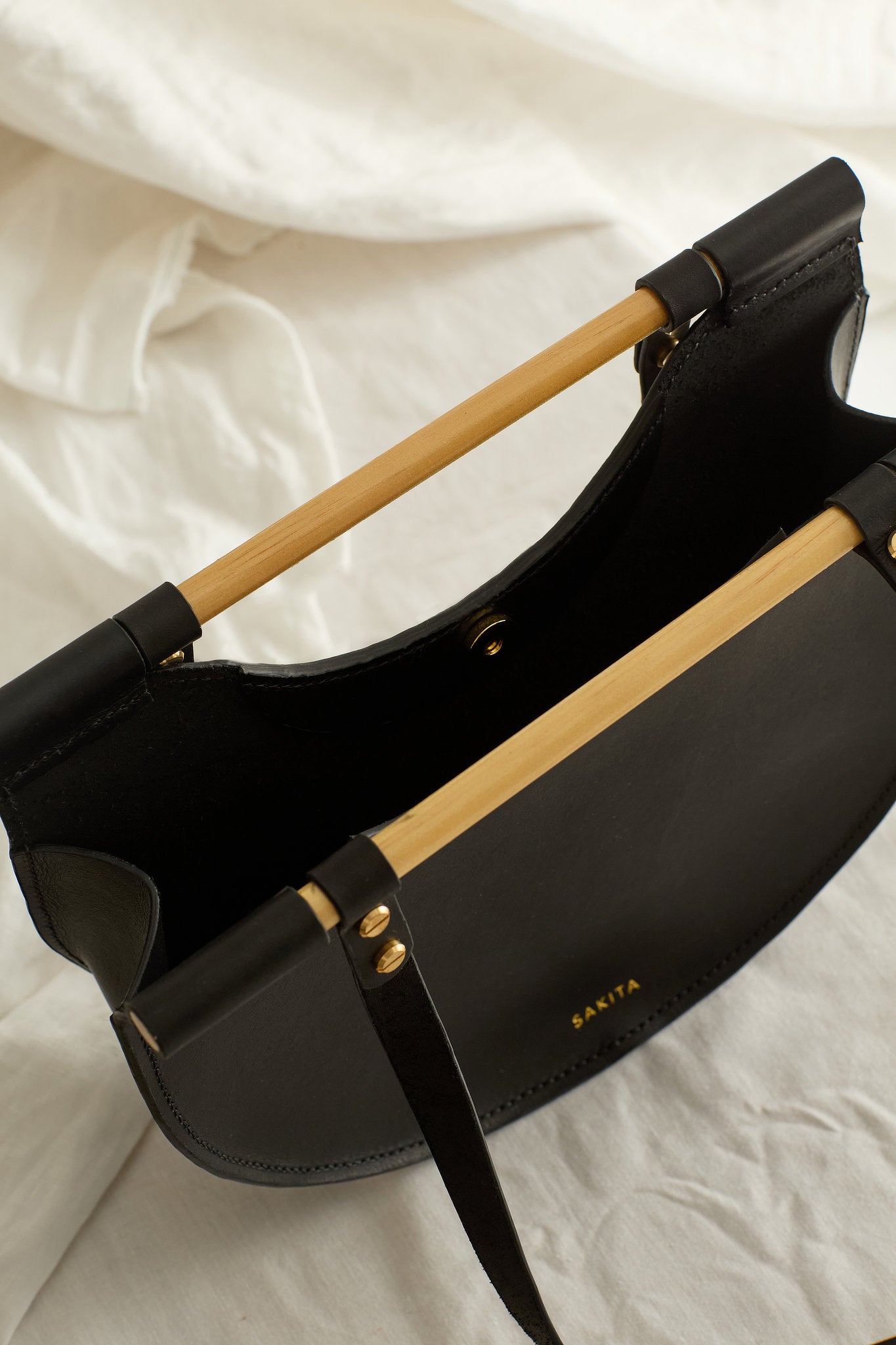 Aerial view of the Celine leather shoulder bag in black showing the raw interior