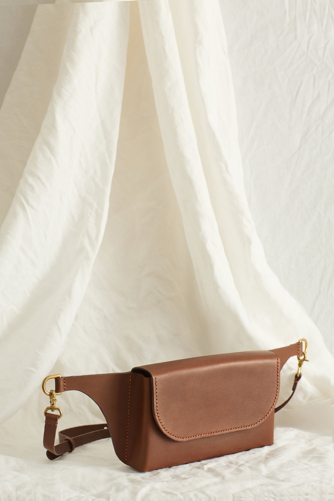 Angled view of the Effie leather belt bag in brown