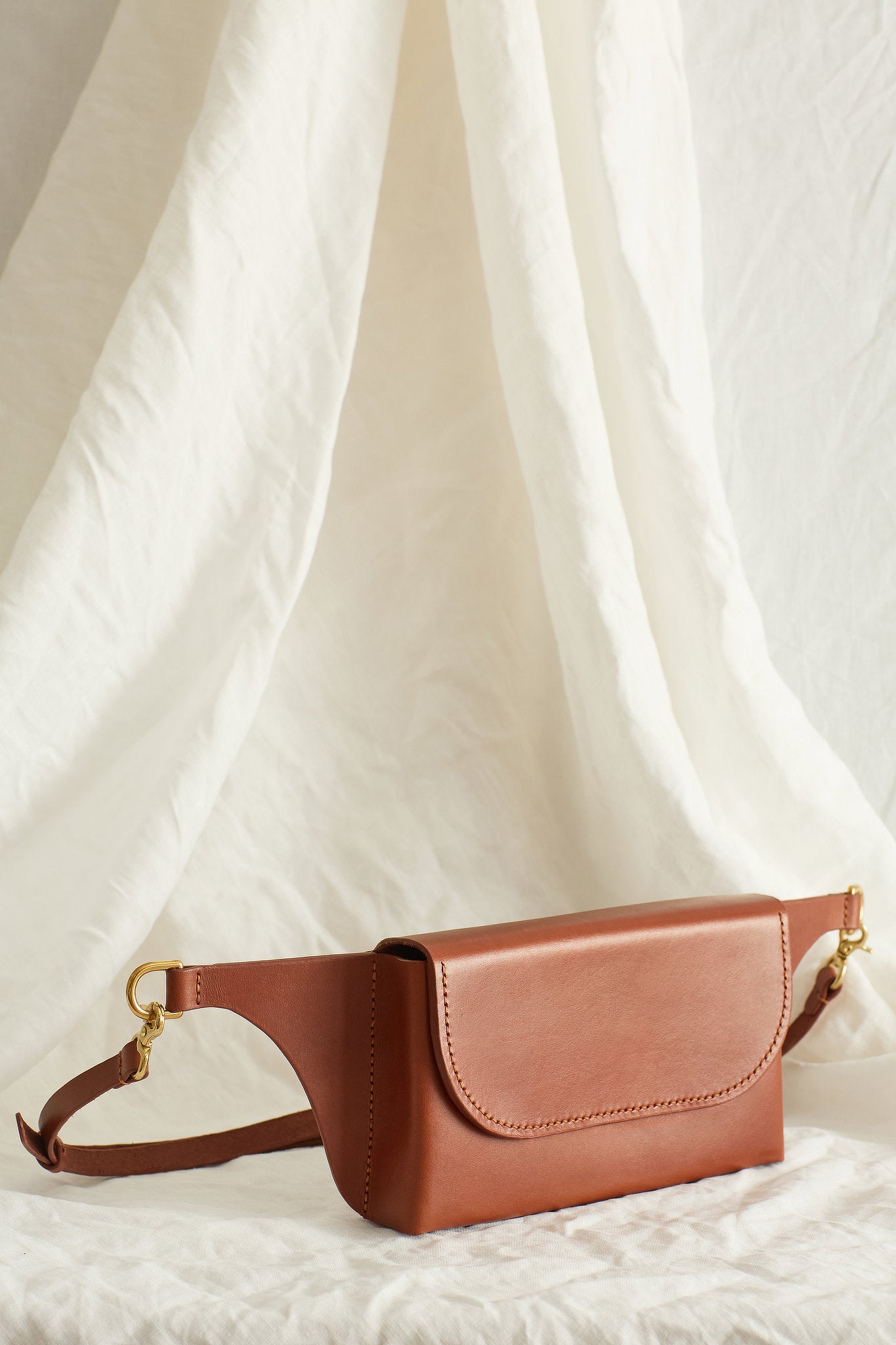Side view of the Effie leather belt bag in maroon