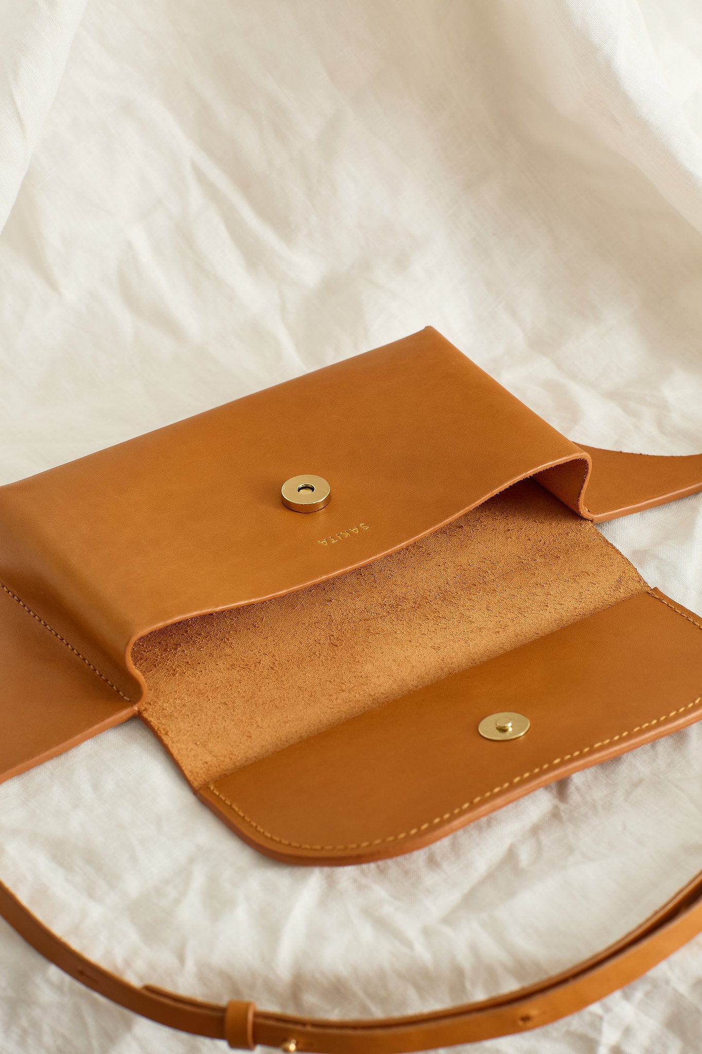 Aerial view of the Effie leather belt bag in tan showing the raw interior
