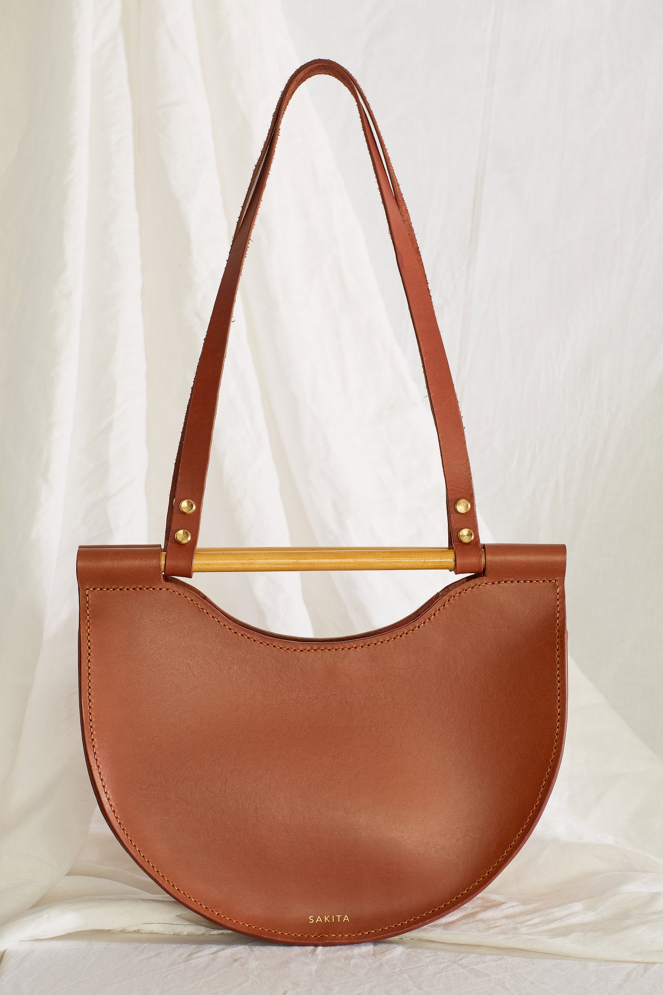 Front view of the Celine half moon leather shoulder bag in maroon