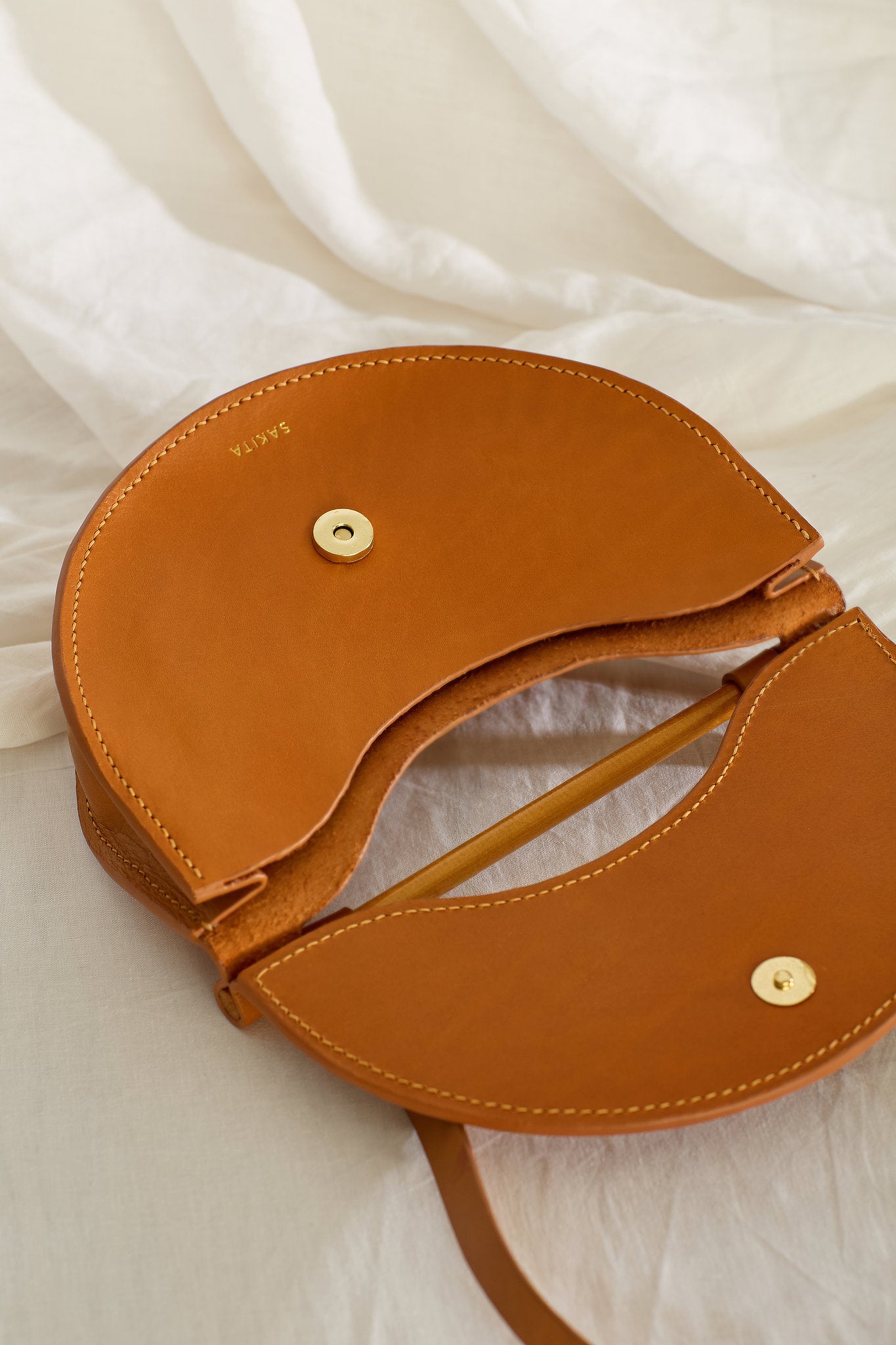 Aerial view of the unlined Elodie leather bag with flap open