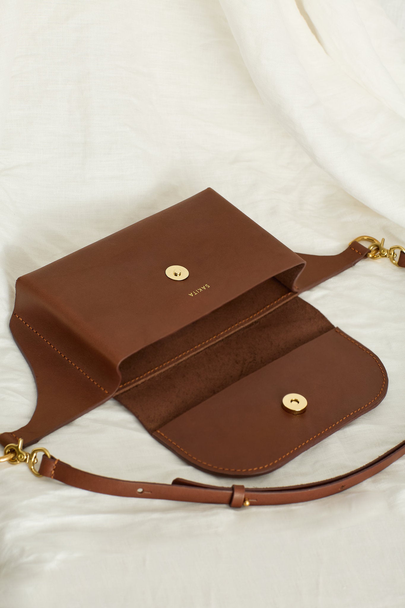 Aerial view of the Effie leather belt bag in maroon showing the unlined interior